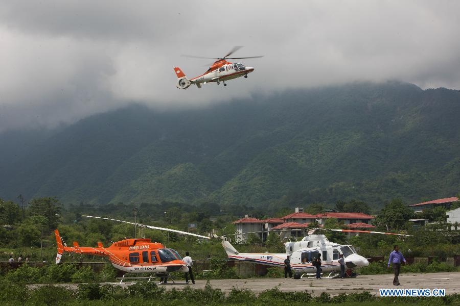 A helicopter takes off from the airport in Dehradun, northern Indian state of Uttarakhand, June 26, 2013. There are still an estimated 7000 people stranded in the flood while authorities use military planes and helicopters in the rescue in flood-ravaged northern India. (Xinhua/Zheng Huansong)