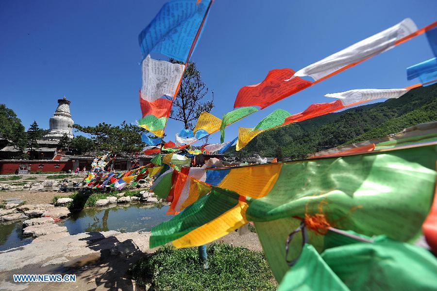 Colorful prayer flags are seen on Mount Wutai, one of four sacred Buddhist mountains in China, in north China's Shanxi Province, June 26, 2013. Added to UNESCO's World Heritage List in 2009, Mount Wutai is home to about 50 Buddhist temples built between the 1st century AD and the early 20th century. (Xinhua/Zhan Yan)