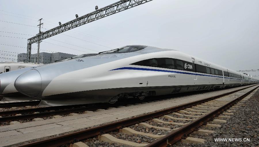 Photo taken on June 27, 2013 shows China's first intelligent high-speed test train produced by CSR Qingdao Sifang Co., Ltd waits to be tested in Qingdao, a coastal city in east China's Shandong Province. The test train, with China Railway High-Speed (CRH) 380A train as its technical platform, is China's first large transport vehicle applied with the Internet of Things technology and sensor networks technology, through which passengers could enjoy modern information services like e-ticket and Wi-Fi. (Xinhua/Li Ziheng)
