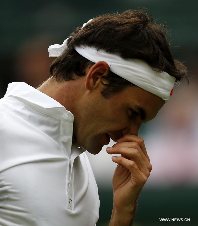 Roger Federer of Switzerland reacts during the second round of men's singles against Sergiy Stakhovsky of Ukraine on day 3 of the Wimbledon Lawn Tennis Championships at the All England Lawn Tennis and Croquet Club in London, Britain, on June 26, 2013. Roger Federer lost 1-3. (Xinhua/Yin Gang)