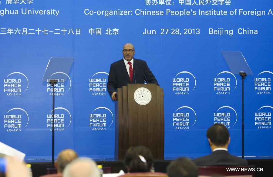 Surinamese President Desi Bouterse addresses the opening ceremony of the 2nd World Peace Forum at Tsinghua University in Beijing, capital of China, June 27, 2013. (Xinhua/Xie Huanchi)