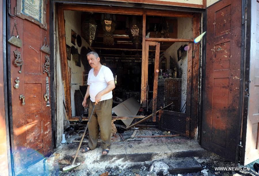 An old man cleans up a destroyed shop at the site of blast in Damascus, capital of Syria, on June 27, 2013. At least four people were killed and many others wounded when a suicide bombing struck near the Mariamieh Patriarchate in the old quarter of the Syrian capital Damascus on Thursday, local media said. (Xinhua/Zhang Naijie) 