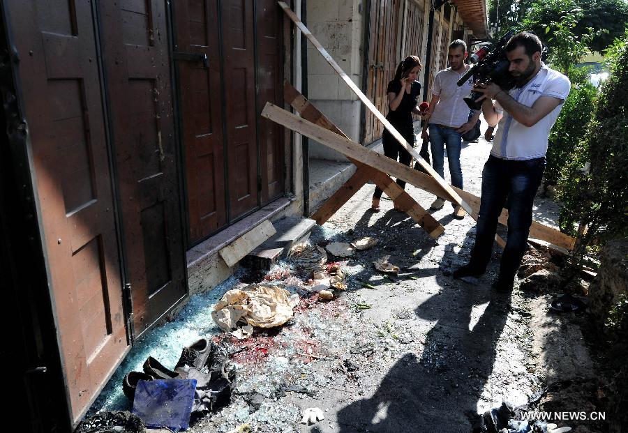 Journalists work at the site of blast in Damascus, capital of Syria, on June 27, 2013. At least four people were killed and many others wounded when a suicide bombing struck near the Mariamieh Patriarchate in the old quarter of the Syrian capital Damascus on Thursday, local media said. (Xinhua/Zhang Naijie)