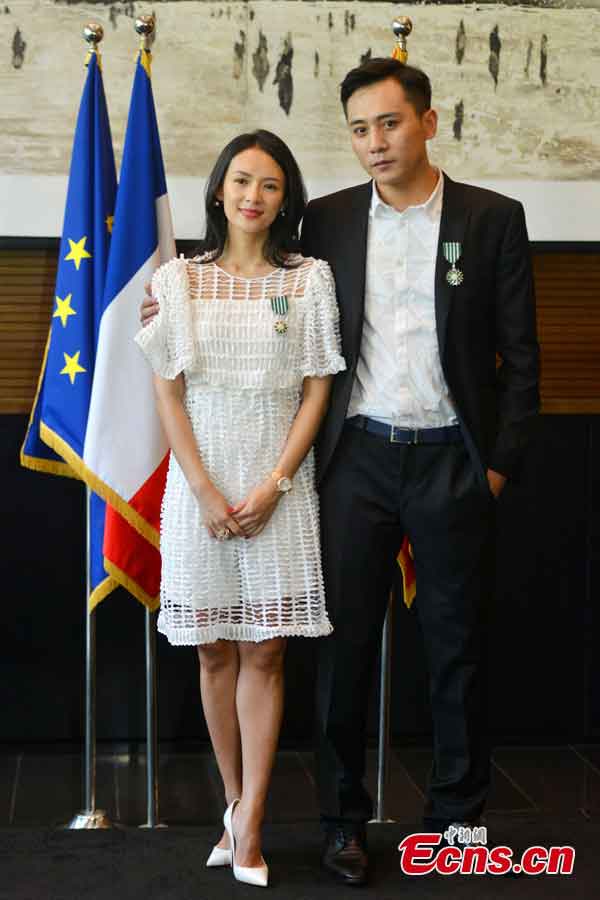 Actor Liu Ye (R) and actress Zhang Ziyi (L) pose for photo after they received the Order of Arts and Letters by the French government in Beijing, capital of China, June 27, 2013. Established in 1957, the order is the recognition of significant contributions to the arts and literature.  (CNS/Li Xueshi)