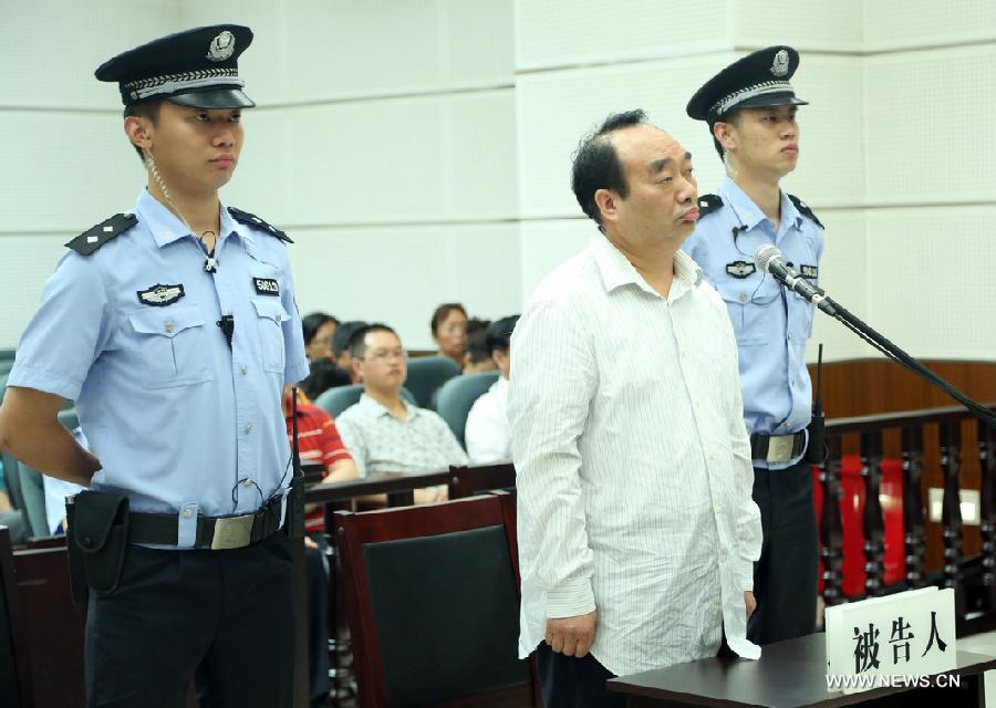 Lei Zhengfu (C, front), former secretary of Chongqing's Beibei District Committee of the Communist Party of China, waits for sentence at the Chongqing No. 1 Intermediate People's Court in southwest China's Chongqing, June 28, 2013. Lei who was embroiled in a sex video scandal was sentenced to 13 years in jail for bribery and fined 300,000 yuan (48,554 U.S. dollars).  