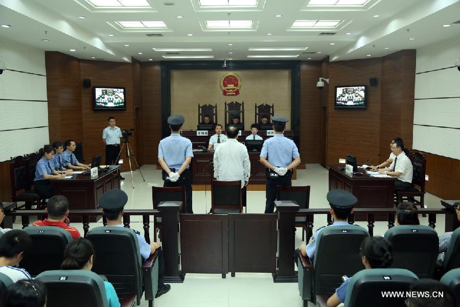 Lei Zhengfu, former secretary of Chongqing's Beibei District Committee of the Communist Party of China, waits for sentence at the Chongqing No. 1 Intermediate People's Court in southwest China's Chongqing, June 28, 2013. Lei who was embroiled in a sex video scandal was sentenced to 13 years in jail for bribery and fined 300,000 yuan (48,554 U.S. dollars).  