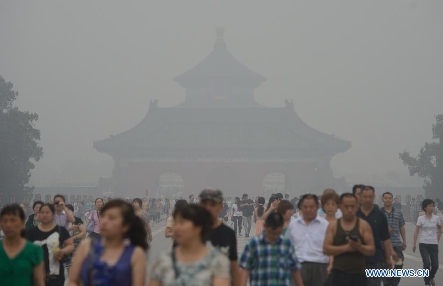 People visit the Temple of Heaven in haze in Beijing, capital of China, June 28, 2013. Most parts of Beijing are shrouded by severe haze on Friday. (Xinhua/Wang Qingqin)