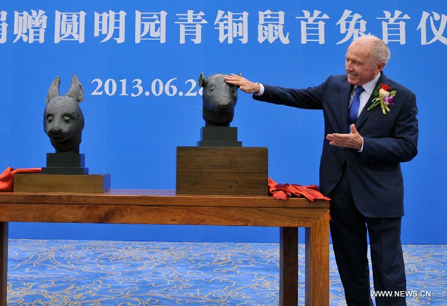 Francois-Henri Pinault, CEO of PPR Foundation and the "owner" of two bronze animal head sculptures, unveils a handover ceremony of the heads plundered by western invaders one-and-a-half centuries ago in Beijing, capital of China, June 28, 2013. The heads of a rat and a rabbit, parts of a fountain clock that previously stood at the Old Summer Palace, or "Yuanmingyuan" in Chinese, were donated on April 26, 2013 by the Pinault family, which owns the French luxury brand Kering. The handover ceremony was held Friday at National Museum of China. (Xinhua/Li Xin)