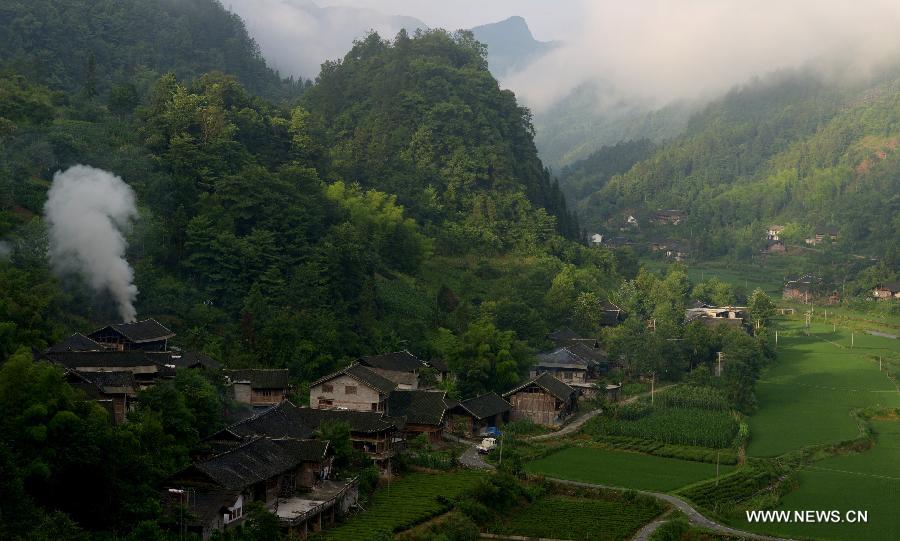 Photo taken on June 27, 2013 shows the morning scenery of stilted buildings at Jinlongba Village in Enshi City, central China's Hubei Province. The Jinlongba Village was listed among the 646 Chinese Traditional Villages in 2012 and villagers here followed the traditional way of living. (Xinhua/Yang Shunpi) 