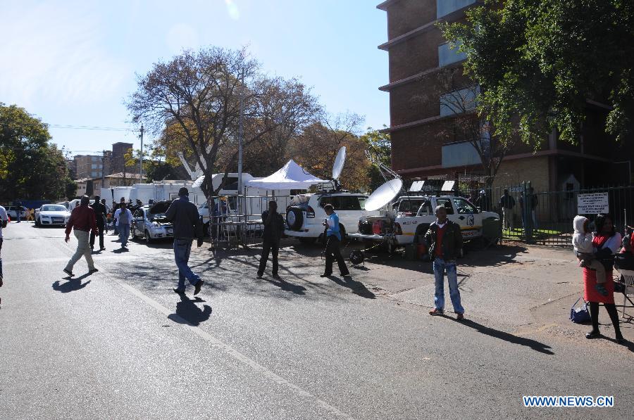 Media vehicles, tents and equipments are seen outside the hospital where South Africa's anti-apartheid icon Nelson Mandela gets medical treatment in Pretoria, South Africa, on June 28, 2013. Mandela's condition continues to improve, Mandela's ex-wife Winnie Madikizela-Mandela said on Friday. (Xinhua/Guo Xinghua) 