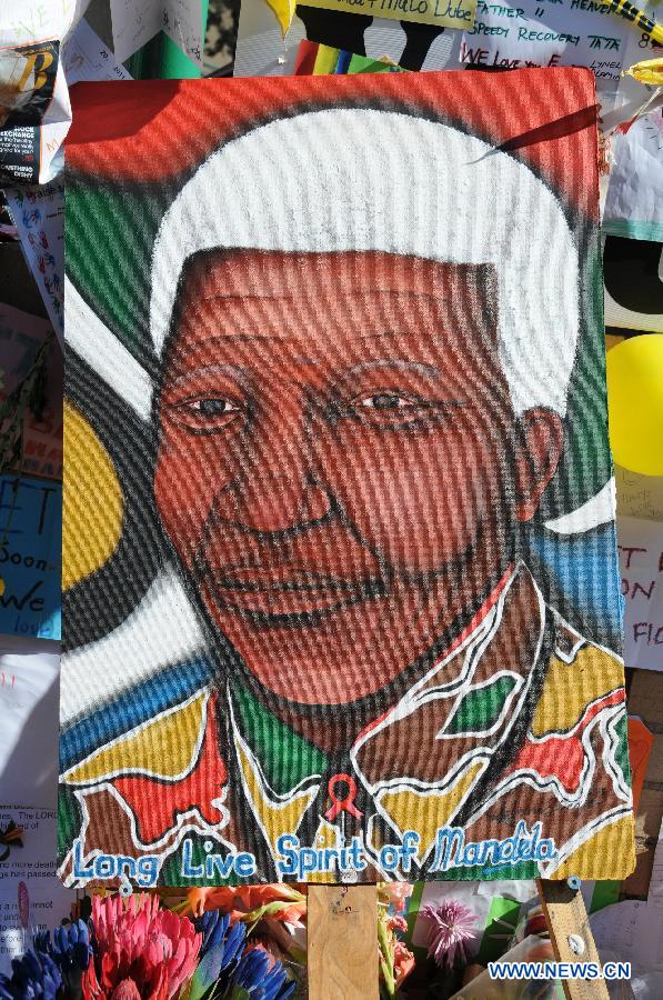 A portrait of South Africa's anti-apartheid icon Nelson Mandela is seen outside the hospital where Mandela gets medical treatment in Pretoria, South Africa, on June 28, 2013. Mandela's condition continues to improve, Mandela's ex-wife Winnie Madikizela-Mandela said on Friday. (Xinhua/Guo Xinghua) 