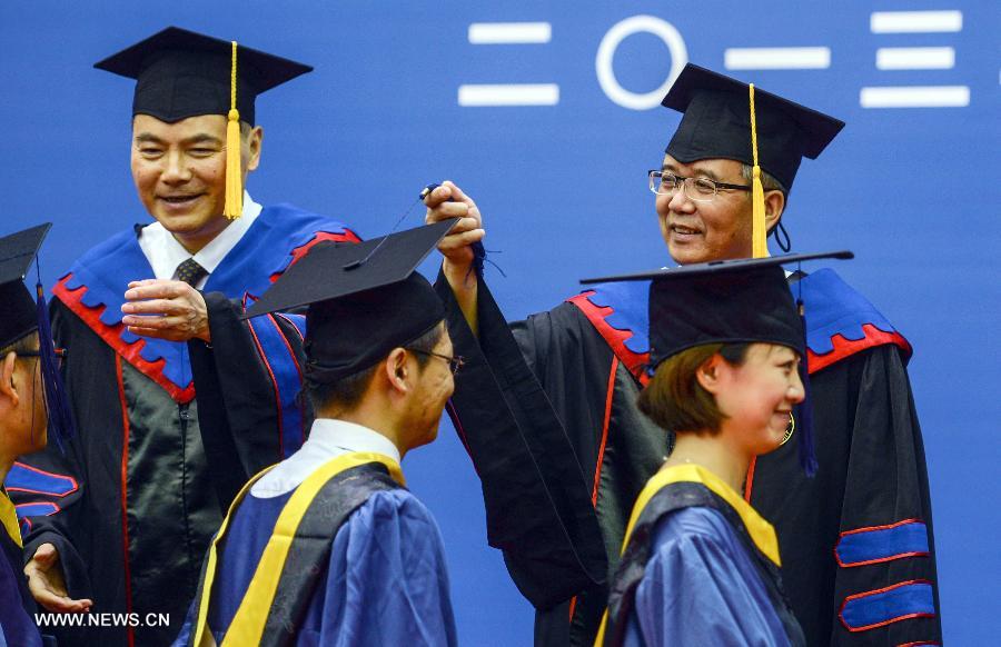 Lin Jianhua(R, back), the new president of Zhejiang University, is seen during the graduation ceremony of Zhejiang University in Hangzhou, capital of east China's Zhejiang Province, June 29, 2013. The graduation ceremony was held here Saturday. (Xinhua/Han Chuanhao)