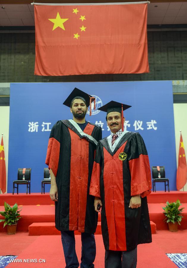 Foreign graduates pose for a group photo during the graduation ceremony of Zhejiang University in Hangzhou, capital of east China's Zhejiang Province, June 29, 2013. The graduation ceremony was held here Saturday. (Xinhua/Han Chuanhao)