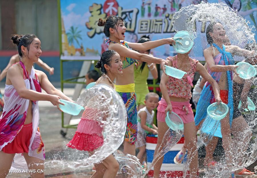 People attend a water-splashing festival during the summer at the Colorful World in Changsha, capital of central China's Hunan Province, June 29, 2013. (Xinhua/Li Ga) 