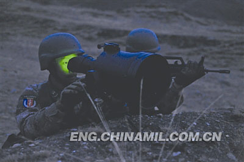Two soldiers are in night reconnaissance with a night vision device. A troop unit of the Chinese People's Liberation Army stationed in Tibet took its officers and men to alpine desert to conduct camouflage and survival training. (Chinamil.com.cn/Zhang Zhen)