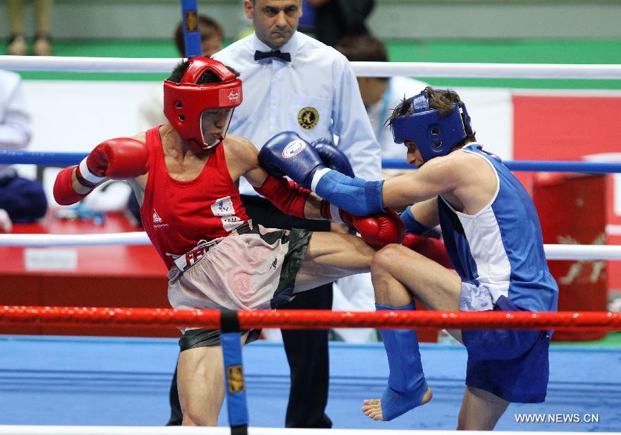 Li Gang (L) of China and Murad Ahmed Salan Murad of Iraq compete during their Muay men's 54kg quarterfinal fight during the 4th Asian Indoor and Martial Arts Games (AIMAG) in Incheon, South Korea, June 30, 2013. Li Gang won 5-0. (Xinhua/Park Jin-hee)