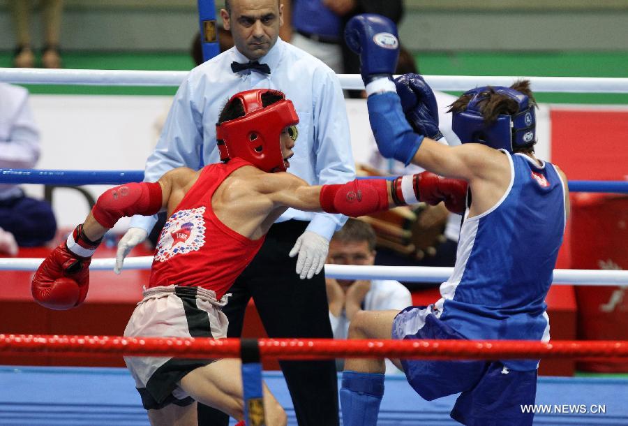 Li Gang (L) of China and Murad Ahmed Salan Murad of Iraq compete during their Muay men's 54kg quarterfinal fight during the 4th Asian Indoor and Martial Arts Games (AIMAG) in Incheon, South Korea, June 30, 2013. Li Gang won 5-0. (Xinhua/Park Jin-hee)