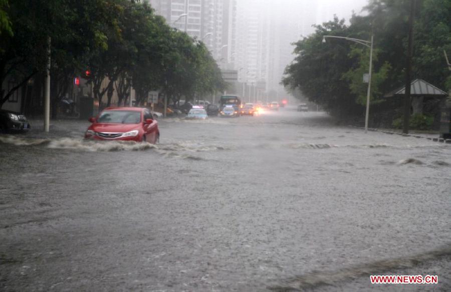 Cars move on a waterlogged street in Suining City, southwest China's Sichuan Province, June 30, 2013. Two people died and five others are missing in Sichuan Province after torrential rain triggered flooding and landslides in the region on Sunday, local authorities said. (Xinhua/Hu Ming) 