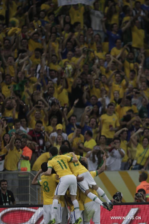 Brazil's players celebrate after scoring during the final of the FIFA's Confederations Cup Brazil 2013 match against Spain, held at Maracana Stadium, in Rio de Janeiro, Brazil, on June 30, 2013. (Xinhua/David de la Paz)