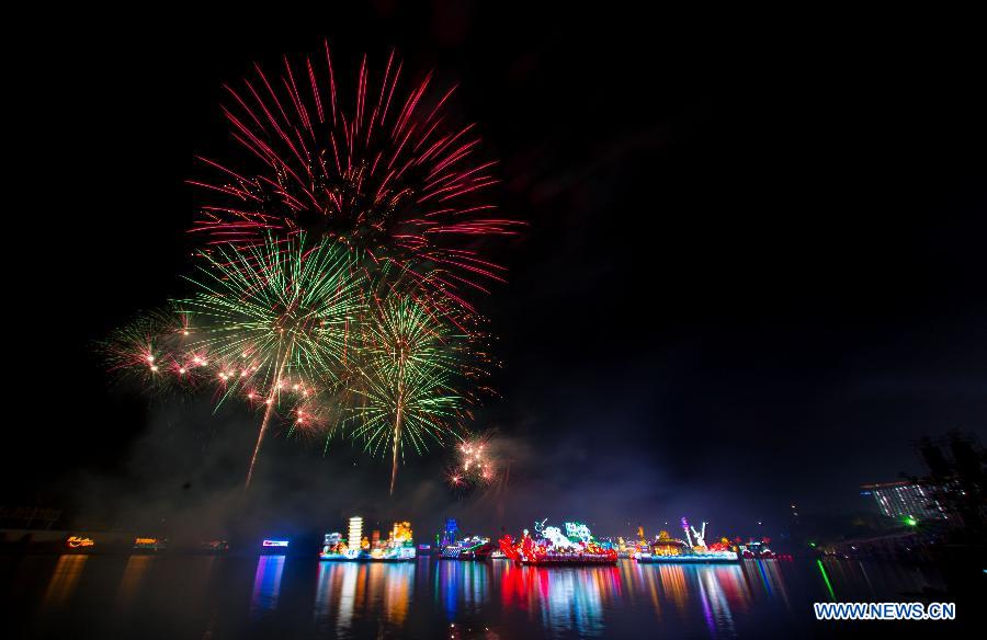 Fireworks explode at the end of the night parade activity in Putrajaya, Malaysia, June 30, 2013. A total of 14 floats attend a night parade activity here on Sunday.(Xinhua/Chong Voon Chung)