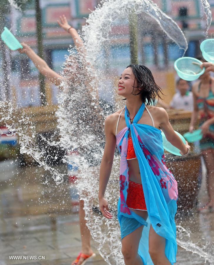 People take part in a water-splashing festival at the Colorful World in Changsha, capital of central China's Hunan Province, June 29, 2013. (Xinhua/Li Ga)