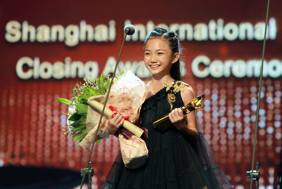 10-year-old Li Xinqiao celebrates winning the Best Actress Award at the Shanghai International Film Festival on June 23, 2013. She became the youngest winner in the history of the festival. (Xinhua/Pei Xin)