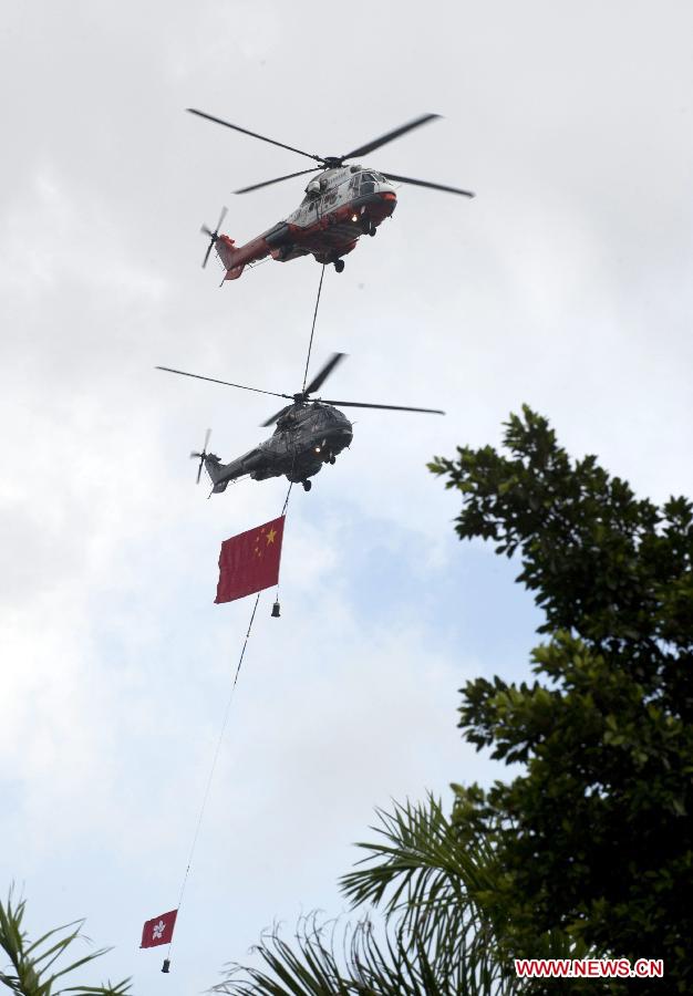 Helicopters carrying Chinese national flag and the flag of the Hong Kong Special Administrative Region fly over Golden Bauhinia Square during the flag-raising ceremony in Hong Kong, south China, July 1, 2013. A flag-raising ceremony is held in Hong Kong Monday to celebrate the 16th anniversary of Hong Kong's return to the motherland. (Xinhua/Lui Siu Wai)