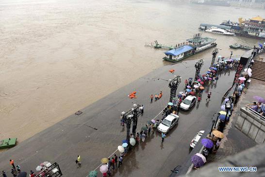 5 missing after floodwaters sink barge in SW China