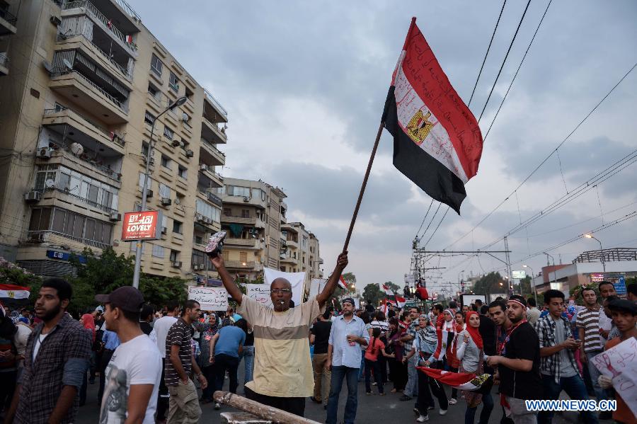 Members of opposition groups attend an anti-President Mohamed Morsi rally calling for the ouster of Morsi near the presidential palace in Cairo, Egypt, on July 1, 2013. The Egyptian military issued a statement hours ago, giving "all parties" a 48-hour deadline to respond to the demands of the people, has been seen by security and political experts as necessary to resolve the current political crisis in the turmoil-stricken country. (Xinhua/Qin Haishi)