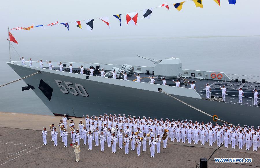 Officers and soldiers of Chinese navy take part in a ceremony for the departure of a fleet in the port of Qingdao, east China's Shandong Province, July 1, 2013. A Chinese fleet consisting of seven naval vessels departed from east China's harbor city of Qingdao on Monday to participate in Sino-Russian joint naval drills scheduled for July 5 to 12. The eight-day maneuvers will focus on joint maritime air defense, joint escorts and marine search and rescue operations. (Xinhua/Zha Chunming)