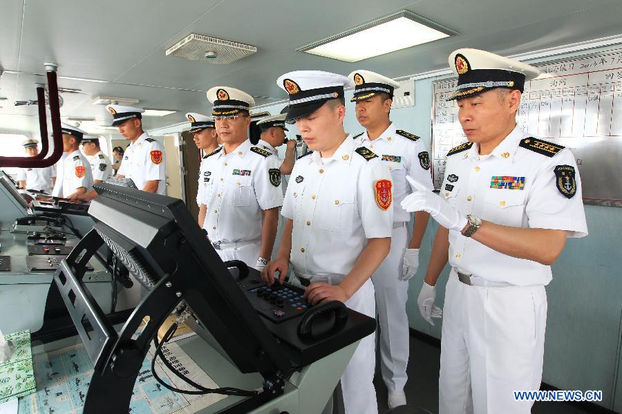 Officers and soldiers of Chinese navy operate on the destroyer Shenyang while departing from the port of Qingdao, east China's Shandong Province, July 1, 2013. A Chinese fleet consisting of seven naval vessels departed from east China's harbor city of Qingdao on Monday to participate in Sino-Russian joint naval drills scheduled for July 5 to 12. The eight-day maneuvers will focus on joint maritime air defense, joint escorts and marine search and rescue operations. (Xinhua/Zha Chunming)