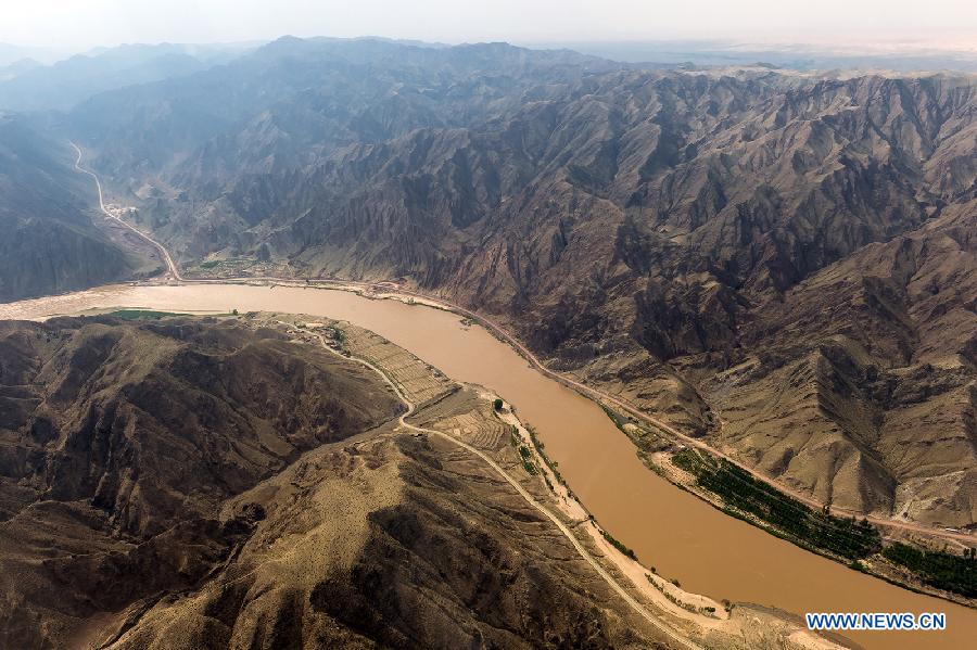 The Yellow River flows in Zhongwei, a city in northwest China's Ningxia Hui Autonomous Region, June 29, 2013. The Yellow River, China's second longest which stretches for nearly 100 kilometers in Zhongwei, runs mainly in the Heishan Gorge. (Xinhua/Wang Peng)