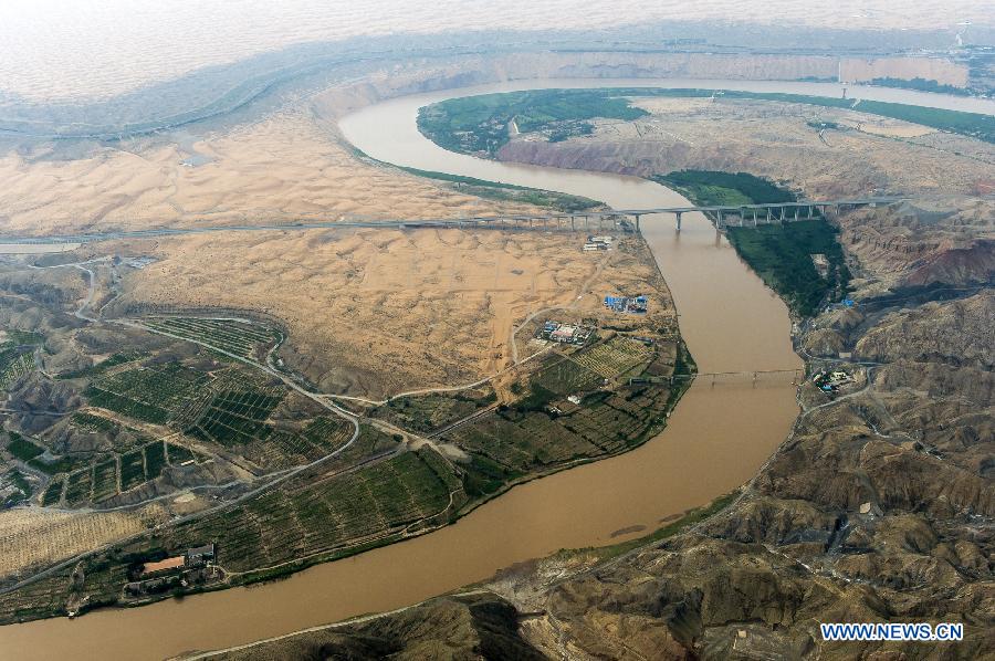 The Yellow River flows in Zhongwei, a city in northwest China's Ningxia Hui Autonomous Region, June 29, 2013. The Yellow River, China's second longest which stretches for nearly 100 kilometers in Zhongwei, runs mainly in the Heishan Gorge. (Xinhua/Wang Peng)