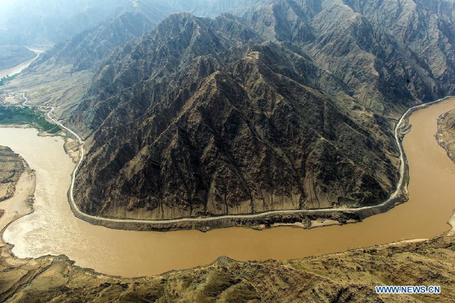 The Yellow River flows in Zhongwei, a city in northwest China's Ningxia Hui Autonomous Region, June 29, 2013. The Yellow River, China's second longest which stretches for nearly 100 kilometers in Zhongwei, runs mainly in the Heishan Gorge. (Xinhua/Wang Peng)