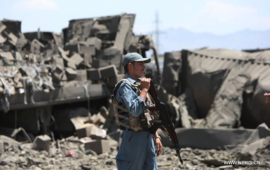 Afghan soldiers stand guard at the site of attack in Kabul, Afghanistan, on July 2, 2013. Twelve people including, five Taliban suicide bombers, four Nepalese contractor guards, one Afghan guard and two civilians, were killed in the attack, officials said. (Xinhua/Ahmad Massoud)