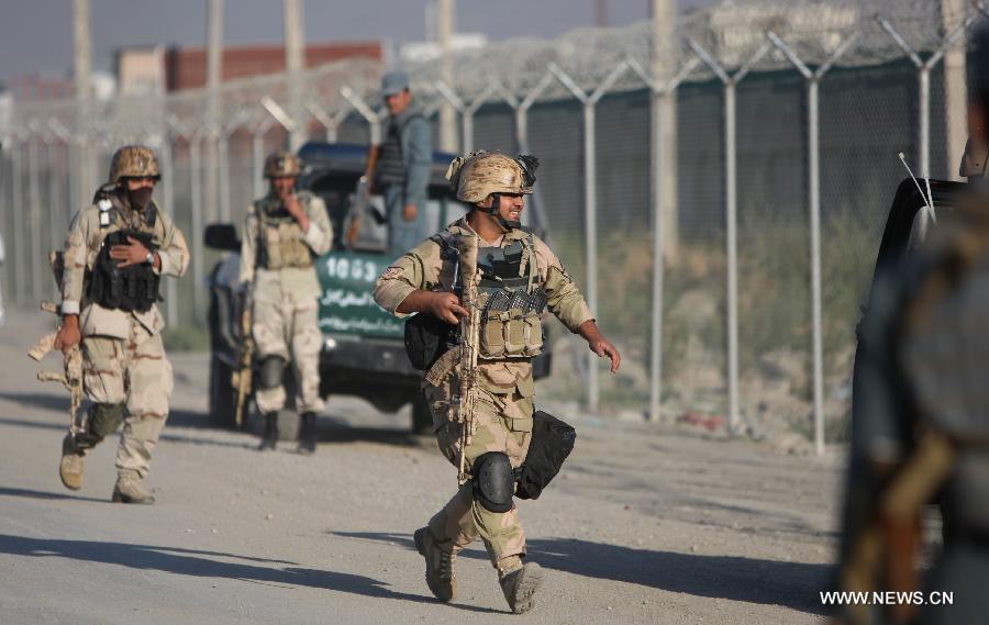 Afghan soldiers run to the site of attack in Kabul, Afghanistan, on July 2, 2013. Twelve people including, five Taliban suicide bombers, four Nepalese contractor guards, one Afghan guard and two civilians, were killed in the attack, officials said. (Xinhua/Ahmad Massoud)