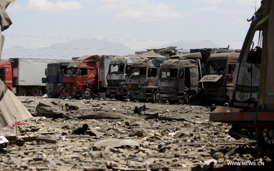 Damaged trucks are seen at the site of attack in Kabul, Afghanistan, on July 2, 2013. Twelve people including, five Taliban suicide bombers, four Nepalese contractor guards, one Afghan guard and two civilians, were killed in the attack, officials said. (Xinhua/Ahmad Massoud)