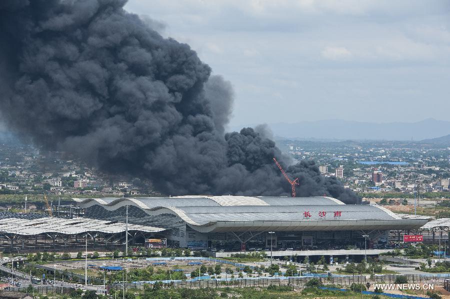 Heavy smoke billows from a warehouse near the Changsha South Railway Station in Changsha, capital of central China's Hunan Province, July 2, 2013. A fire engulfed the warehouse Sunday without injuring anyone. Local fire department took more than two hours to douse the fire. (Xinhua/Zeng Xiangping)