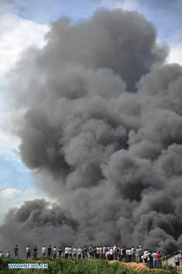 Heavy smoke billows from a warehouse near the Changsha South Railway Station in Changsha, capital of central China's Hunan Province, July 2, 2013. A fire engulfed the warehouse Sunday without injuring anyone. Local fire department took more than two hours to douse the fire. (Xinhua/Li Ga) 