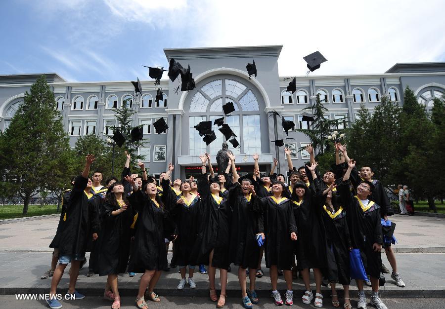 Graduates pose for photos in the Taiyuan University of Technology in Taiyuan, capital of north China's Shanxi Province, July 2, 2013. The Taiyuan University of Technology held a graduation ceremony for its more than 5,800 graduates on Tuesday. (Xinhua/Yan Yan)