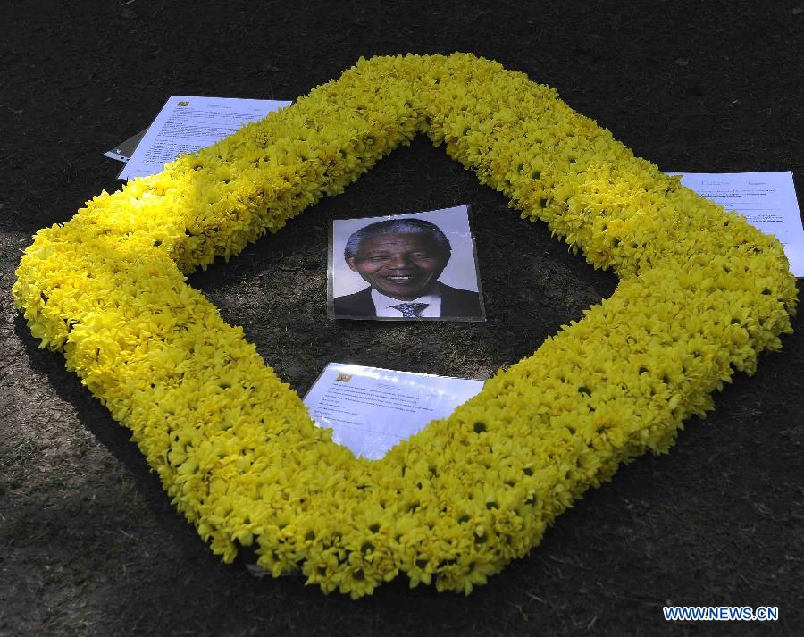 A garland of flowers is seen outside Nelson Mandela's house in Johannesburg, South Africa, on July 2, 2013. South Africans are ready to celebrate the 95th birthday of anti-apartheid icon Nelson Mandela who has been hospitalized for more than three weeks for a recurring lung infection, President Jacob Zuma said. Zuma said Mandela "is still critical but stable" in a Pretoria hospital where he was admitted on June 8. (Xinhua/Li Qihua)