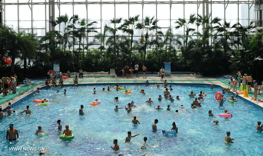 Citizens enjoy coolness at a natatorium in Shijiazhuang, capital of north China's Hebei Province, July 3, 2013. The highest temperatures in many parts of Hebei reached 37 degrees celsius on Wednesday. (Xinhua/Wang Xiao)