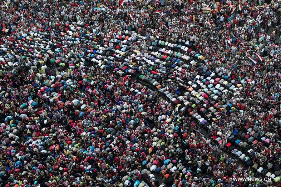 Opponents of Egyptian President Mohammed Morsi pray at Cairo's Tahrir Square, Egypt, on July 3, 2013. Egypt's President Mohamed Morsi said Wednesday he would commit to his own roadmap of building a coalition government and setting up a panel for amending the constitution, warning against any other scenarios. (Xinhua/Li Muzi)