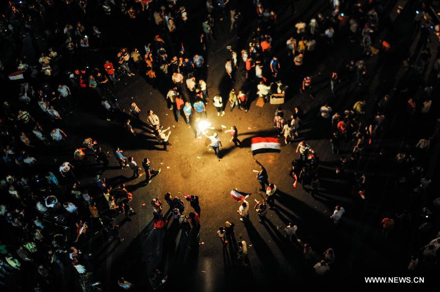 Opponents of Egyptian President Mohammed Morsi celabrate near the presidential palace in Cairo, Egypt, on July 3, 2013. Egyptian interior ministry expressed complete support to a military statement that revealed a roadmap for running the country after the ouster of Islamist President Mohamed Morsi, the ministry said in a statement Wednesday. (Xinhua/Qin Haishi)