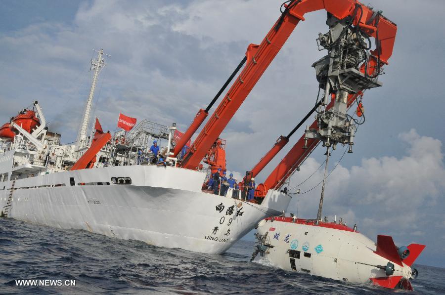 China's manned submersible Jiaolong is hoisted by its support ship Xiangyanghong 09 after a deep-sea dive into the south China sea, July 3, 2013. The Jiaolong manned submersible on Wednesday carried out a scientific dive to conduct geological sampling on a complex terrain. (Xinhua/Zhang Xudong)
