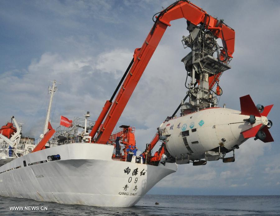 China's manned submersible Jiaolong is hoisted by its support ship Xiangyanghong 09 after a deep-sea dive into the south China sea, July 3, 2013. The Jiaolong manned submersible on Wednesday carried out a scientific dive to conduct geological sampling on a complex terrain. (Xinhua/Zhang Xudong)