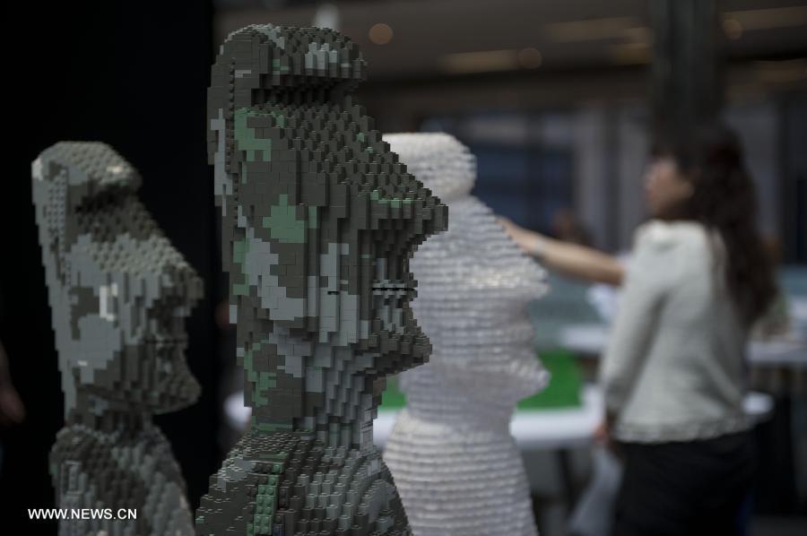 Visitors view exhibits at the preview of a LEGO exhibition at the Cityplaza in Hong Kong, south China, July 4, 2013. Featuring 40 world heritage sites with over half a million LEGO bricks, the exhibition will be held from July 5 to July 31. (Xinhua/Lui Siu Wai)
