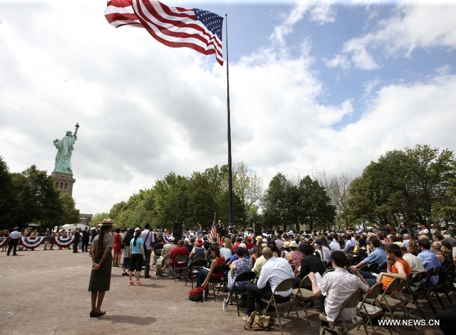 People attend reopening ceremony of the Statue of Liberty at Liberty Island in New York, the United States, on July 4, 2013, the U.S. Independence Day. The Statue of Liberty and Liberty Island reopened to the public on Thursday for the first time since Hurricane Sandy made landfall on Oct. 29, 2012. (Xinhua/Cheng Li) 
