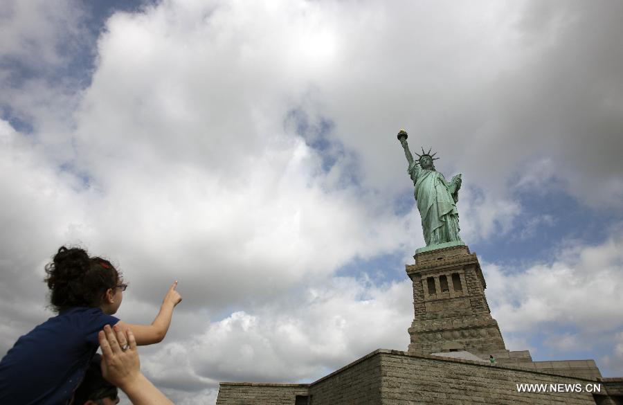 People visit the Statue of Liberty at Liberty Island in New York, the United States, on July 4, 2013, the U.S. Independence Day. The Statue of Liberty and Liberty Island reopened to the public on Thursday for the first time since Hurricane Sandy made landfall on Oct. 29, 2012. (Xinhua/Cheng Li) 