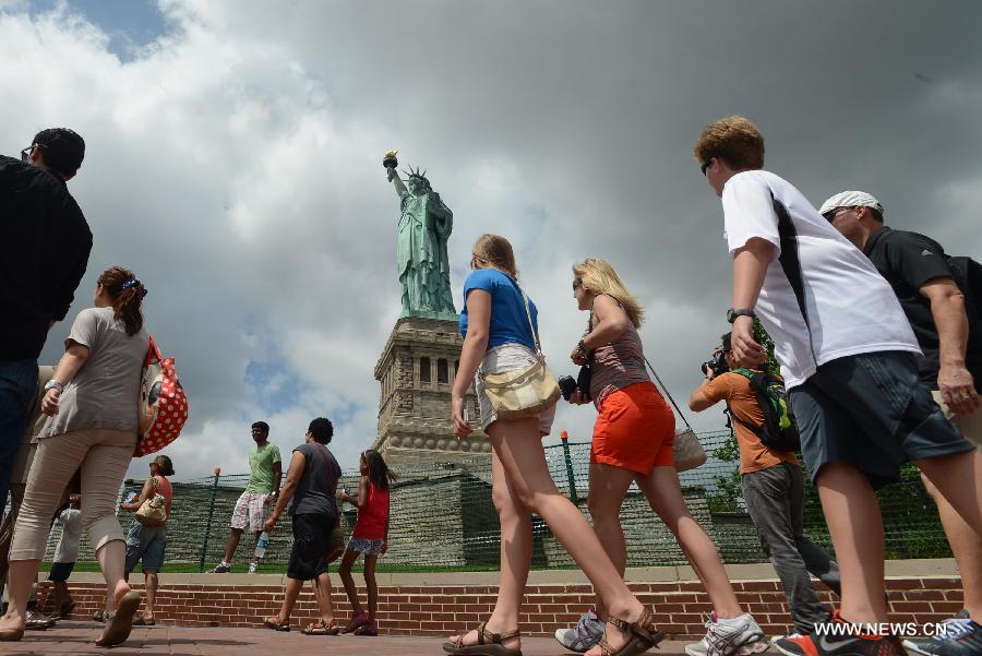 People visit the Statue of Liberty at Liberty Island in New York, the United States, on July 4, 2013, the U.S. Independence Day. The Statue of Liberty and Liberty Island reopened to the public on Thursday for the first time since Hurricane Sandy made landfall on Oct. 29, 2012. (Xinhua/Wang Lei) 